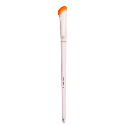 Pincel de maquiagem bege com cerdas alaranjadas e logotipo da marca "Marykay" impresso. O pincel possui um design elegante e compacto