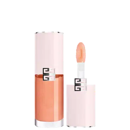 Produto de maquiagem com embalagem rosa e laranja, com logotipo Givenchy visível. Frasco cilíndrico com aplicador na ponta, contendo produto de textura cremosa em tom salmão.
