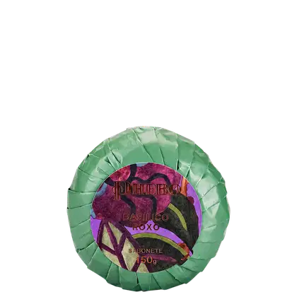 Sabonete em forma circular com embalagem verde-clara, rótulo roxo com texto "Phebo Basilico roxo" e ilustração floral.