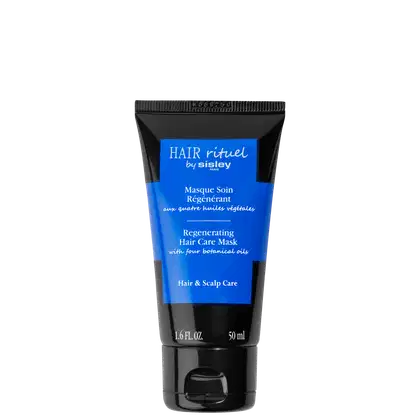 Bisnaga preta e azul da linha Hair Rituel by Sisley, com rótulo azul exibindo o nome da marca e o produto "Masque Soin Régénérant", um tratamento capilar regenerador com quatro óleos vegetais.