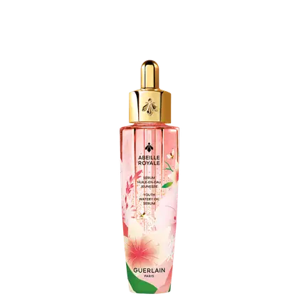 Frasco de vidro rosa com tampa dourada contendo o sérum "Abeille Royale" da Guerlain, com detalhes florais e texto em francês descrevendo o produto como um sérum de óleo aquoso para juventude.