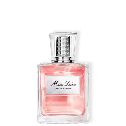 Frasco de item de perfumaria da marca Dior com rótulo em texto cursivo preto sobre fundo rosa claro, em formato retangular com tampa transparente.