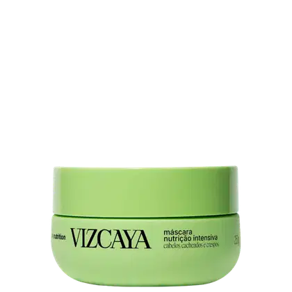 Embalagem verde-clara em formato de pote contendo a inscrição "VIZCAYA" e "máscara nutrição intensiva" em preto. O produto é destinado a cabelos cacheados e crespos.