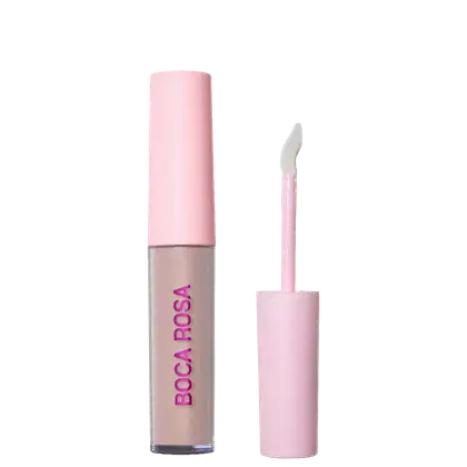Corretivo líquido Boca Rosa em frasco com tampa rosa e aplicador, embalagem cilíndrica rosa com texto em magenta, apresentado aberto mostrando produto bege claro.