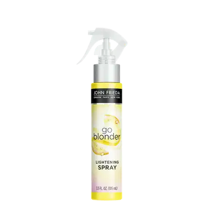 Embalagem plástica amarela com borrifador. O rótulo exibe o logotipo John Frieda em preto, o nome do produto "Go Blonder Lightening Spray".