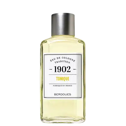 Frasco de Eau de Cologne da linha 1902 Tradition, com rótulo branco e preto destacando o nome "Tonique" e o ano 1902. Embalagem de vidro com tampa metálica prateada, contendo um líquido amarelado.