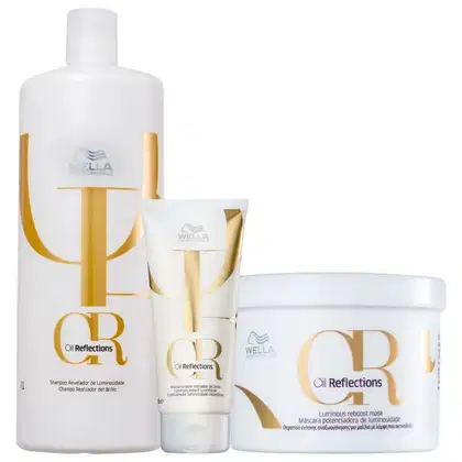 Produtos da linha Oil Reflections da Wella Professionals, incluindo um frasco de shampoo, um tubo de condicionador e um pote de máscara, todos com design em branco e dourado.