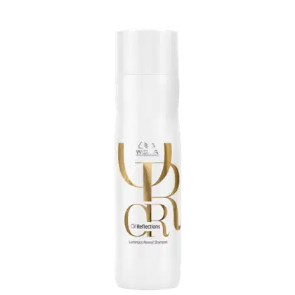 Frasco branco de shampoo da linha Oil Reflections da Wella Professionals, com rótulo dourado destacando o nome do produto "Luminous Reveal Shampoo".