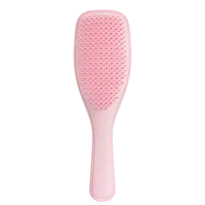 Escova de cabelo rosa da marca Tangle Teezer, com superfície texturizada e formato ergonômico para facilitar o penteado.