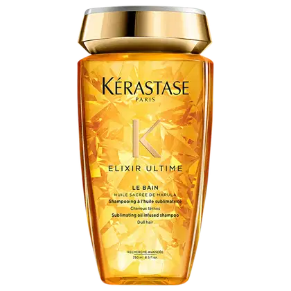 Frasco de shampoo da marca Kérastase Paris, com design dourado e rótulo destacando o nome "Elixir Ultime" e a descrição "Shampooing à l'huile sublimatrice", indicando um shampoo com óleo sublimador. O frasco possui 250 ml de capacidade.