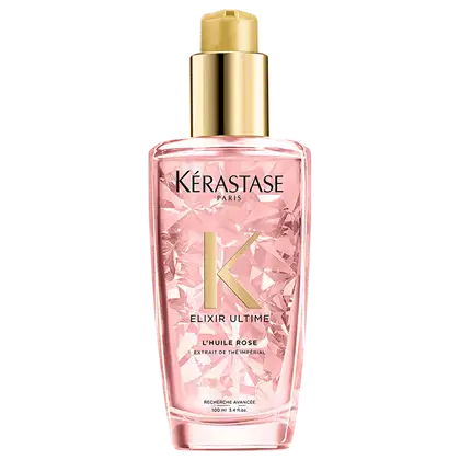 Frasco rosa com tampa dourada contendo o produto "Elixir Ultime L'Huile Rose" da marca Kérastase Paris, um óleo capilar de tratamento.