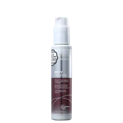 Frasco branco de 100 ml da linha Defy Damage da Joico, com rótulo prateado e roxo, apresentando um escudo protetor para proteger contra danos térmicos e UV.