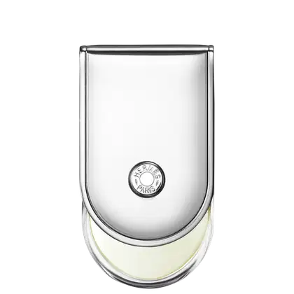 Frasco de perfume Hermès em vidro transparente com tampa arredondada. Rótulo circular com a marca Hermès Paris impresso em preto. Líquido incolor visível no interior do frasco.