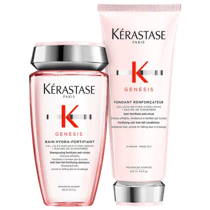 Dois produtos Kérastase Genesis: um frasco de shampoo hidratante fortificante anti-queda e um tubo de condicionador fortificante anti-queda, ambos com embalagens rosa e branca e rótulos com o logotipo da marca.