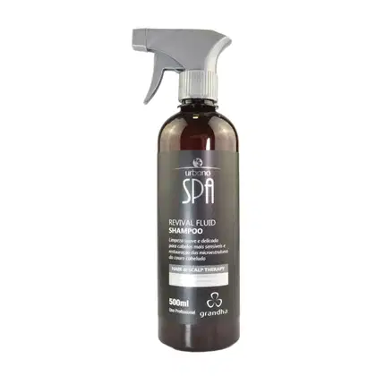 Frasco de shampoo em spray da linha Urbano Spa da Grandha, com 500ml de capacidade. Apresenta rótulo em tons de cinza e preto, com informações sobre o produto "Revival Fluid Shampoo" e sua função de terapia capilar e couro cabeludo.