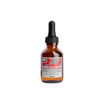 Frasco de vidro âmbar com conta-gotas preto contendo um produto Davines com rótulo vermelho e padrão de paisley. O produto é descrito como um "Energizing Seasonal Superactive" com 100 ml de volume.