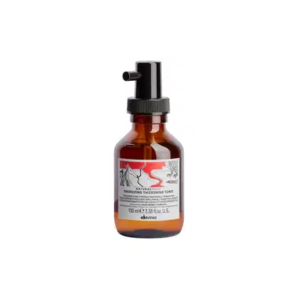 Frasco de 100 ml de tônico energizante e espessante da linha Naturaltech da Davines, com rótulo vermelho e preto destacando o nome do produto.