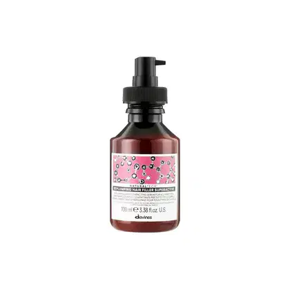 Frasco de 100 ml de Replumping Hair Filler Superactive, um sérum capilar da marca Davines, com embalagem em tons de rosa e preto, contendo informações sobre o produto em inglês.