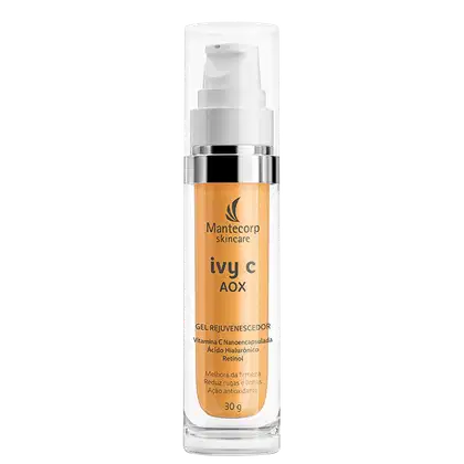 Frasco cilíndrico de 30g transparente com tampa branca. Rótulo laranja com o nome do produto "ivy c AOX" e a marca "Mantecorp skincare". Descrição indicando que contém vitamina C nanoencapsulada, ácido hialurônico e retinol.