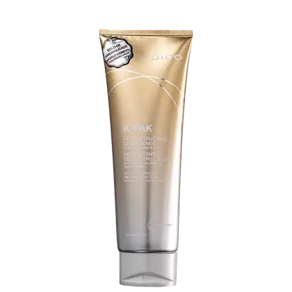 Tubo dourado de condicionador reconstrutor da linha K-Pak da Joico, com rótulo destacando o selo de qualidade. O produto é destinado a cabelos danificados, com 250 ml de volume.