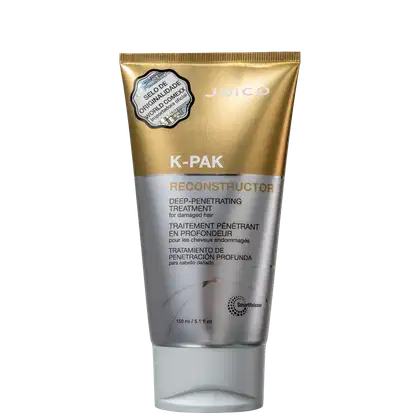 Trata-se de um frasco de tratamento capilar da marca Joico, chamado K-PAK Reconstructor. O produto é apresentado em uma embalagem dourada e prateada, com rótulo destacando suas propriedades de tratamento profundo e penetrante para cabelos danificados.