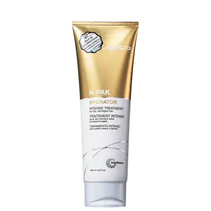 Tubo dourado da marca Joico contendo o produto K-PAK Hydrator, um tratamento intensivo para cabelos secos e danificados. O rótulo destaca o nome do produto e sua função de hidratar intensamente os fios.