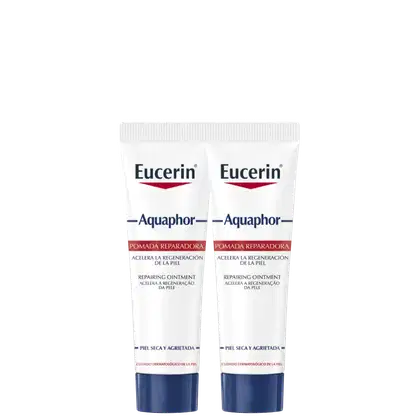 Dois tubos brancos da marca Eucerin contendo pomada reparadora Aquaphor, com rótulos azuis e vermelhos, para cuidados com pele seca e agredida.