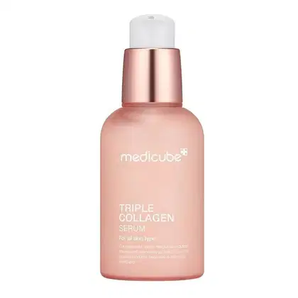 Frasco de soro de colágeno triplo da Medicube, com embalagem em tons de rosa e branco. O produto é indicado para todos os tipos de pele e promete melhorar a aparência da pele.