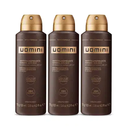 Três frascos de desodorante antitranspirante aerossol da marca Uomini, com embalagem marrom e dourada, exibindo o nome da marca e a descrição em destaque.
