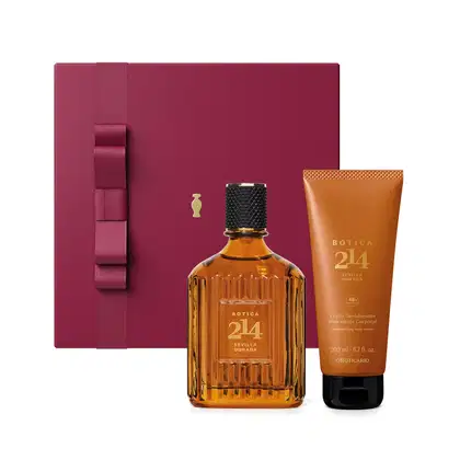 Caixa vinho com laço na mesma cor e detalhe dourado, Eau de Parfum Fougére Aromático Botica 214 em vidro de 90ml com líquido na cor âmbar e tampa preta e bisnaga laranja com letras amarelas e tampa preta contendo 200ml de loção hidratante corporal.