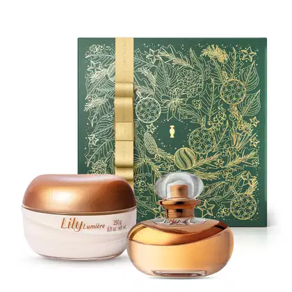 Imagem do Combo Lily Lumière com o luxuoso frasco do Eau De Parfum em tons de dourado com tampa transparente, um pote transparente com tampa dourada do creme hidratante corporal na cor branca e uma caixa presenteável verde com estampa e fita douradas.