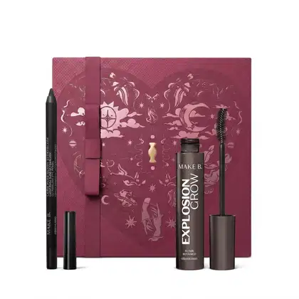 Caixa de presente de cor vinho com um grande coração contendo ilustrações em relevo de temática celestial. Ao lado, dois itens de maquiagem da marca Make B., sendo um lápis para olhos preto e uma máscara de cilios da linha Explosion Crow.