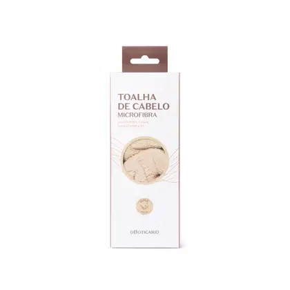 Toalha de cabelo microfibra da marca O Boticário, em embalagem retangular branca com detalhes em marrom, apresentando texto informativo sobre o produto.