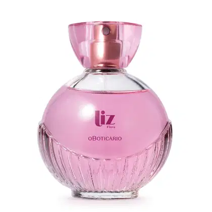 Vidro arredondado com líquido rosa, letras vinho, borrifador dourado e tampa transparente contendo 100ml de desodorante colônia Liz Flora.