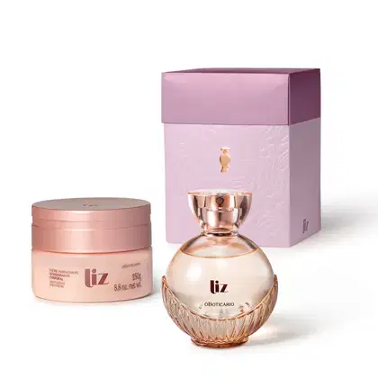Caixa lilás com detalhe dourado e dois produtos da marca Liz: pote em tons de rosa de creme hidratante corporal e vidro arredondado com líquido rosa e tampa dourada de desodorante colônia.