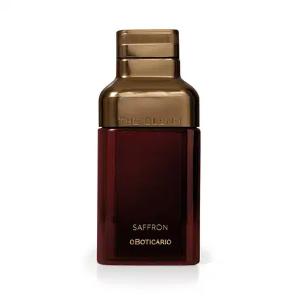 Frasco dourado com rótulo vermelho escuro, contendo o texto "The Blend" e "Saffron oBoticario". O produto possui uma embalagem elegante e sofisticada, com destaque para o tom dourado predominante.
