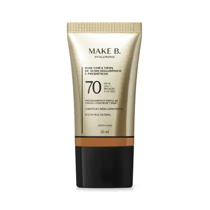 Frasco de base com 8 tipos de ácido hialurônico e probióticos da marca Make B., com FPS 70, UVA+++ e proteção à luz azul. Embalagem em tons de bege e preto, com informações sobre o produto.