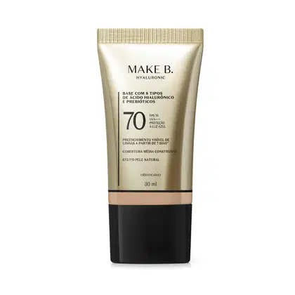 Frasco de base com 8 tipos de ácido hialurônico e probióticos da marca Make B., com FPS 70, UVA+++ e proteção à luz azul. Embalagem em tons de bege e preto, com informações sobre o produto.