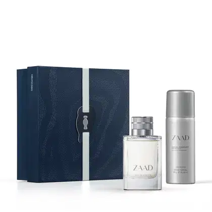 Caixa azul-marinho com padrão de linhas onduladas, contendo um frasco de perfumaria Zaad com rótulo prateado e um desodorante Zaad em embalagem prateada.