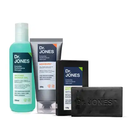 A imagem mostra produtos da marca Dr. Jones. Um shampoo em embalagem transparente com cor verde clara. Um creme abdominal em tubo cinza. Um sabonete corporal preto e a em embalagem também preta.