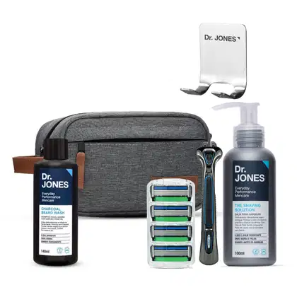Conjunto de produtos de cuidados pessoais da marca Dr. Jones, incluindo um frasco de lavagem para barba, um bálsamo para barbear, um suporte para lâminas de barbear e uma bolsa de transporte cinza.