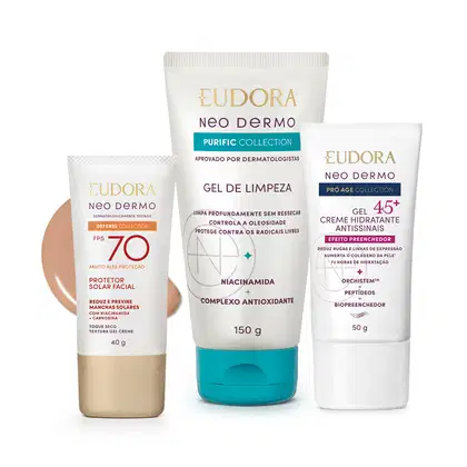 Três produtos da linha Neo Dermo da Eudora: protetor solar facial FPS 70, gel de limpeza e creme hidratante antissinais 45+, em embalagens brancas e azuis com detalhes dourados.