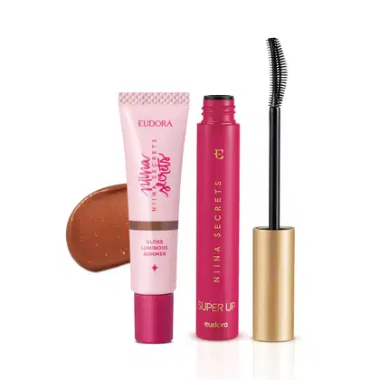Conjunto de produtos de beleza da marca Niina Secrets, incluindo um tubo de gloss luminoso de verão rosa, um rímel preto em embalagem dourada e um blush em tom bronze.