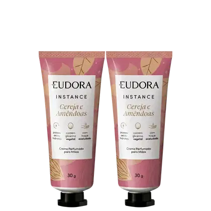 Dois tubos de creme perfumado para mãos da marca Eudora Instance, com design em tons de rosa e detalhes dourados, contendo 30g cada.