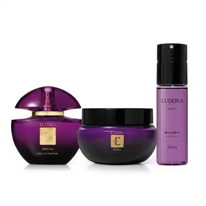 Conjunto de produtos Eudora Absolu, composto por frasco de eau de parfum, pote de creme corporal e frasco de spray corporal, todos em tons de roxo e preto com detalhes dourados.