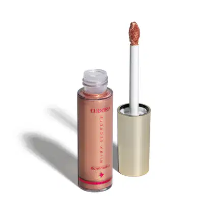 Iluminador Líquido Eudora Niina Secrets Luminous destampado, aplicador posicionado ao lado.