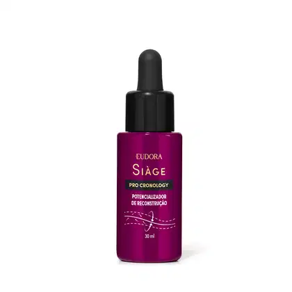 O produto apresentado é um potencializador de reconstrução da linha Siàge Pro Cronology. O frasco possui um conta-gotas preto na parte superior. A embalagem possui uma cor predominante de roxo escuro, com o nome da linha impressos no rótulo.