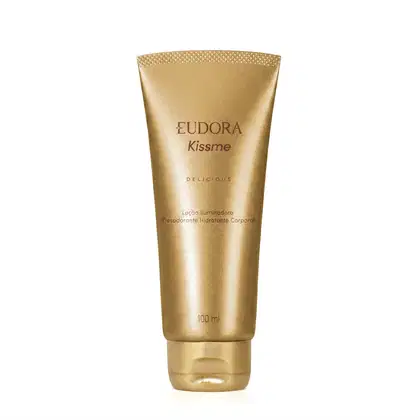Tubo dourado, contendo o texto "Eudora Kiss Me Delicious" em letras marrons. O produto é uma Loção Iluminadora Desodorante Hidratante Corporal com 100 ml.