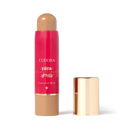 O produto apresentado é um contorno em bastão da linha Niina Secrets. A embalagem é cilíndrica e de cor rosa vibrante, com o nome da marca e da linha impressos em letras douradas. A embalagem também possui um detalhe dourado na parte superior.