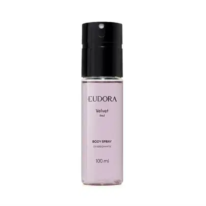 Frasco de item de perfumaria com tom arroxeado. Texto "EUDORA Velvet Soul" visível no rótulo. Embalagem cilíndrica com tampa preta. Escrito: Body Spray Desodorante!. Produto de 100 ml.